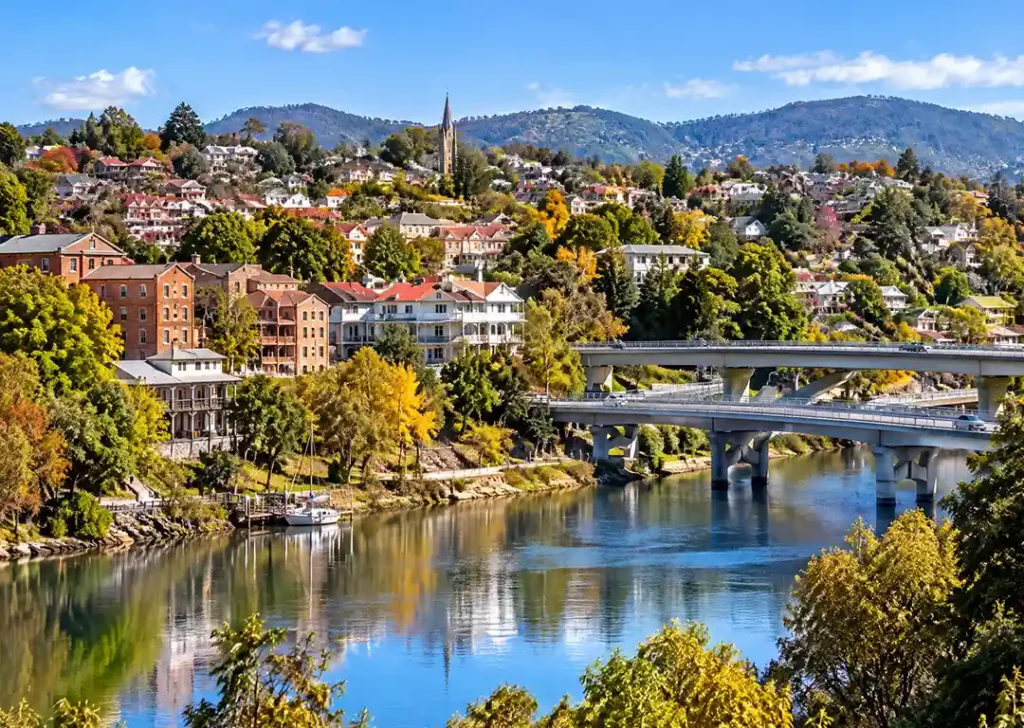 Panoramic view of Launceston heritage architecture and hillside parkland along the calm Tamar River
